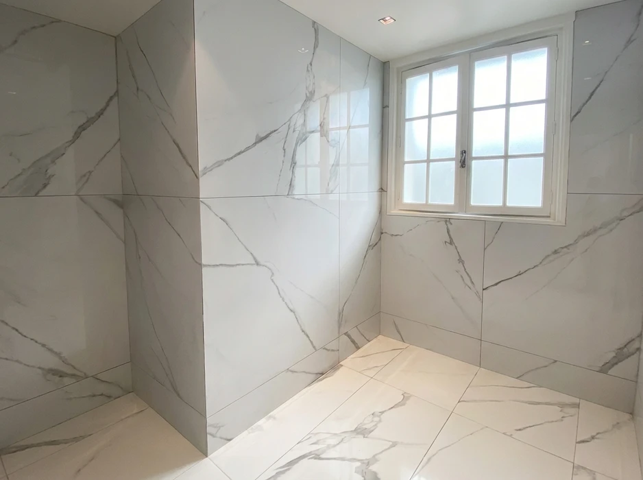 Salle de douche à l'italienne sans receveur, carrelage grand format effet marbre blanc Calacatta avec veines grises, finition polie brillante